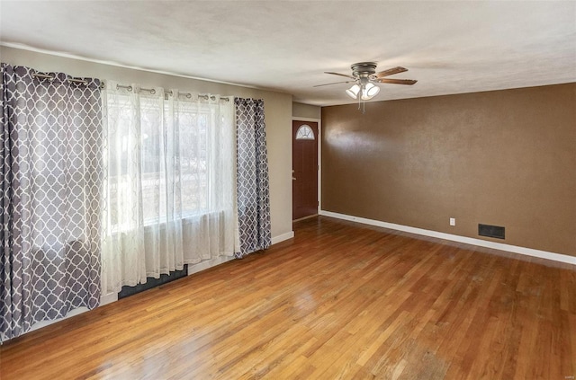 spare room with hardwood / wood-style flooring and ceiling fan