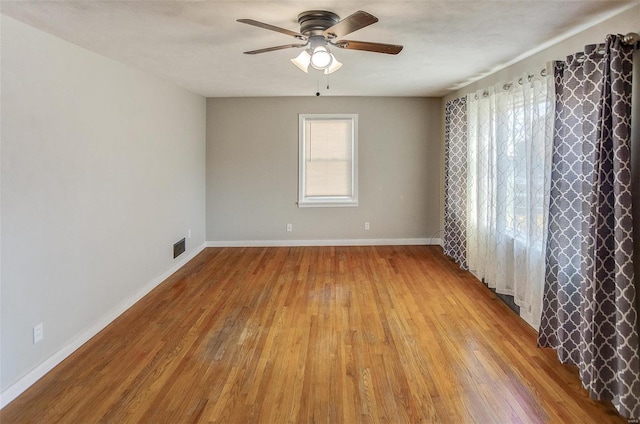 spare room featuring ceiling fan and light hardwood / wood-style flooring