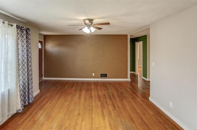 spare room featuring hardwood / wood-style floors and ceiling fan