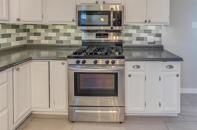 kitchen with backsplash, white cabinetry, light tile patterned floors, and stainless steel appliances