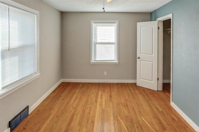 empty room with light hardwood / wood-style flooring