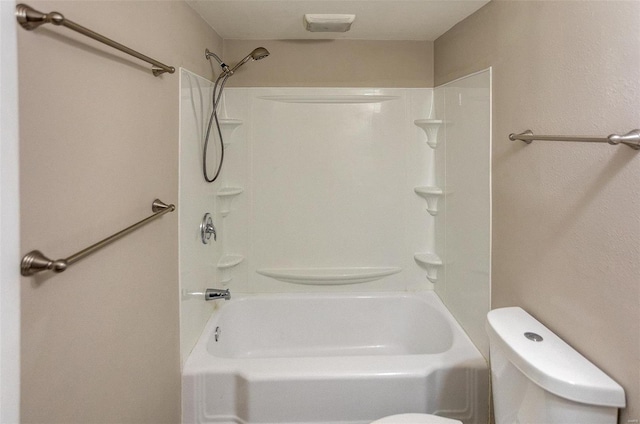 bathroom with bathing tub / shower combination and toilet