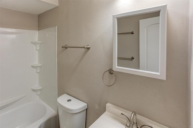 full bathroom with sink, tub / shower combination, and toilet