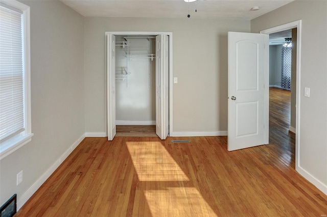 unfurnished bedroom with a closet and light hardwood / wood-style flooring