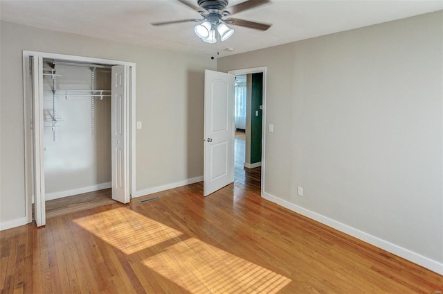 unfurnished bedroom with a closet, ceiling fan, and hardwood / wood-style floors