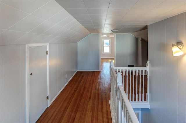 bonus room with vaulted ceiling and dark wood-type flooring