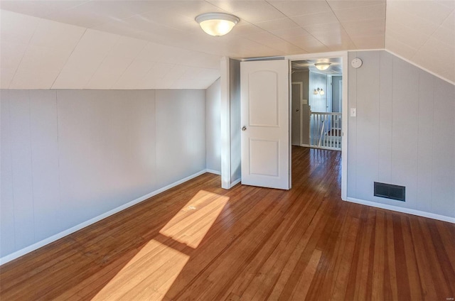 additional living space featuring hardwood / wood-style flooring and lofted ceiling