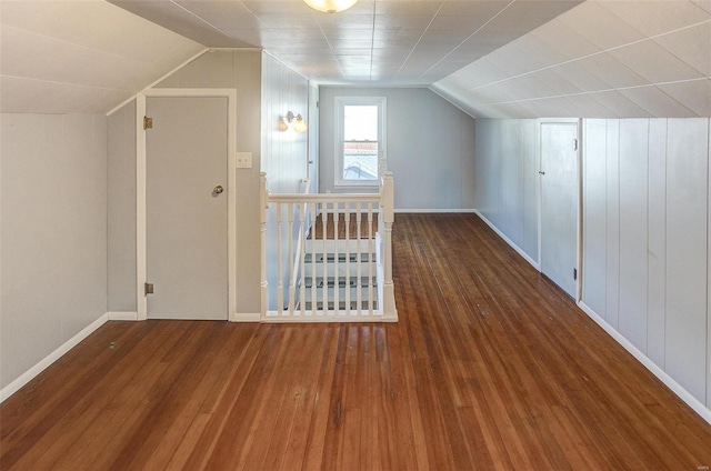 bonus room featuring dark hardwood / wood-style floors and lofted ceiling