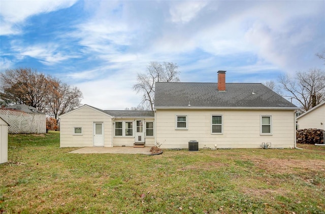 rear view of property featuring a patio area, a yard, and central AC unit