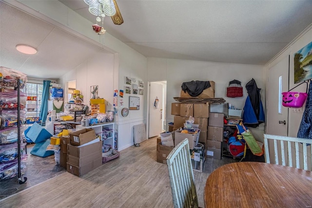 interior space featuring ceiling fan, light hardwood / wood-style floors, lofted ceiling, and a textured ceiling