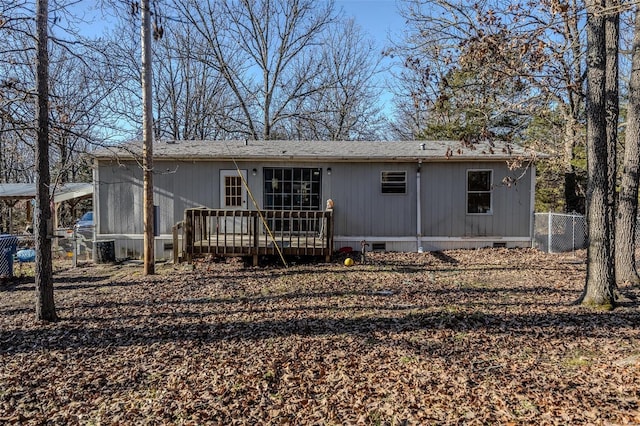 rear view of property featuring a wooden deck