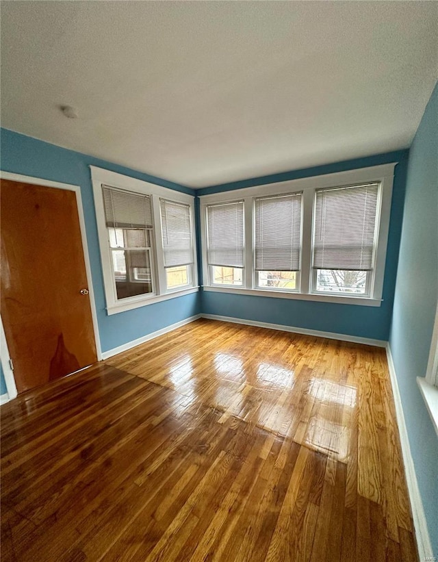 spare room featuring a textured ceiling and hardwood / wood-style flooring