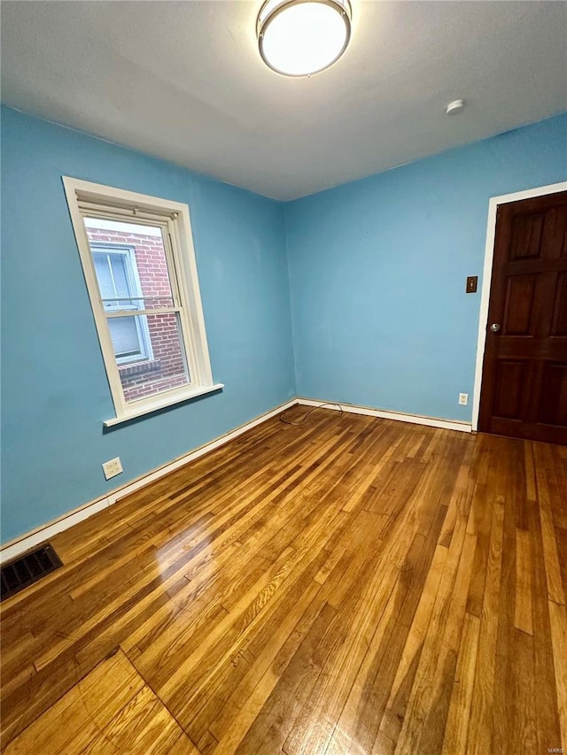 spare room with hardwood / wood-style floors