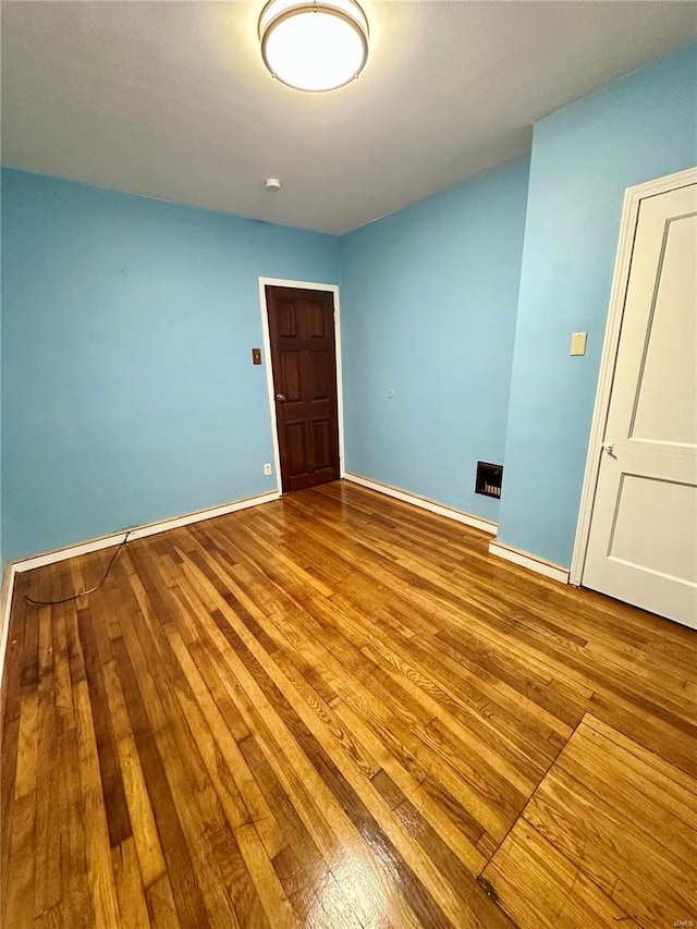 unfurnished room with light hardwood / wood-style flooring