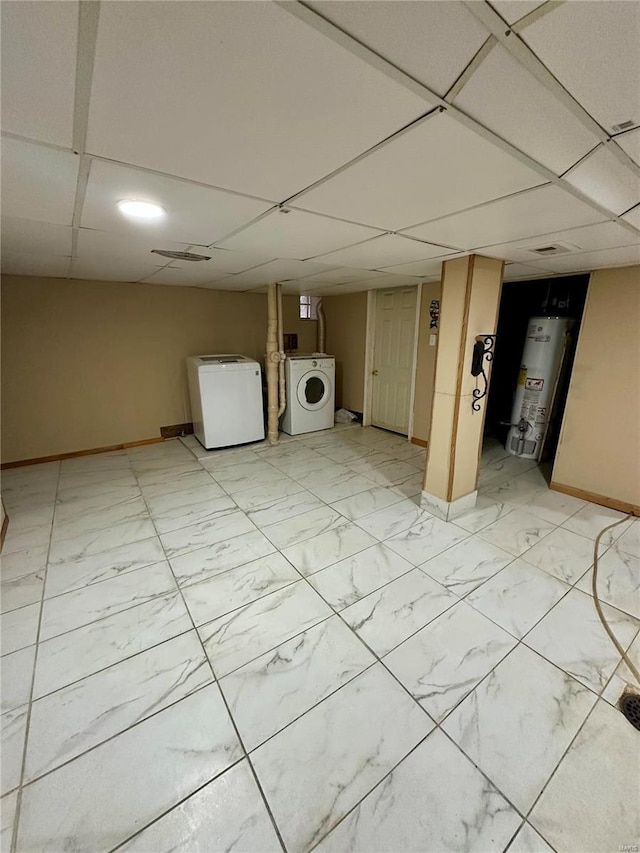 basement with washer / clothes dryer, water heater, and a drop ceiling