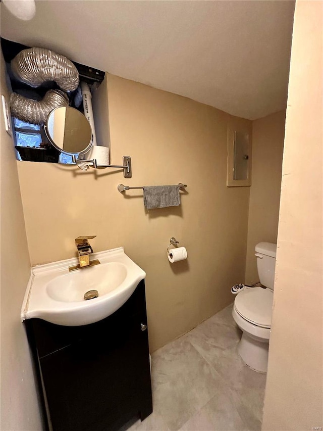 bathroom with vanity, electric panel, and toilet