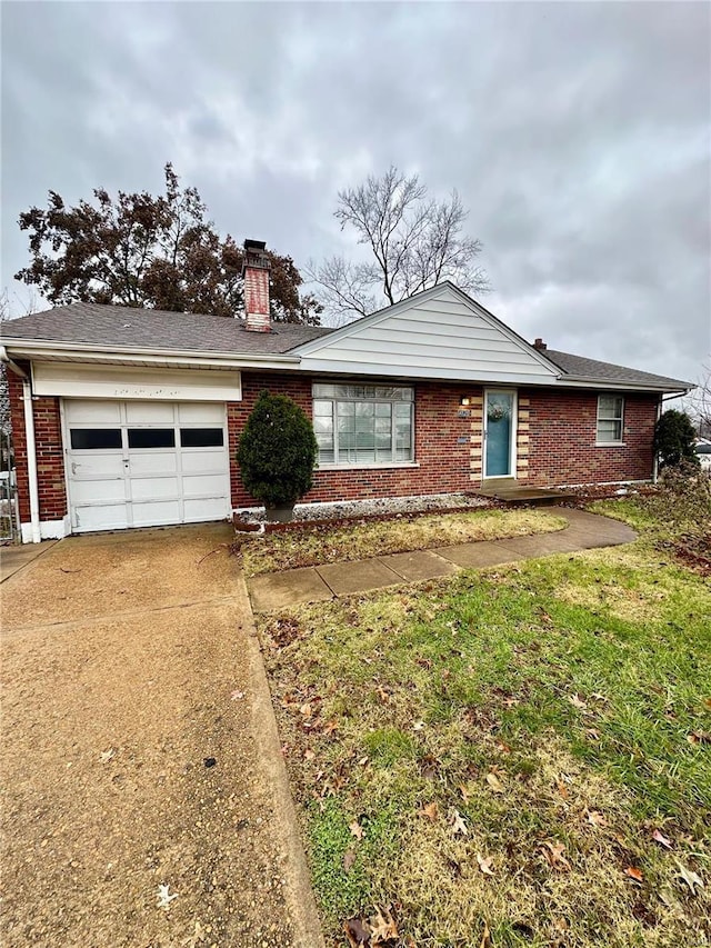 ranch-style house with a garage and a front lawn