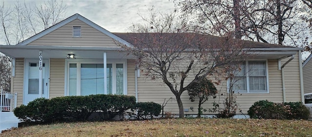 view of side of property featuring covered porch