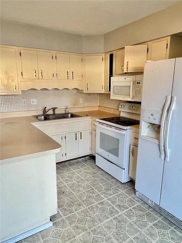 kitchen featuring white appliances, sink, and tasteful backsplash