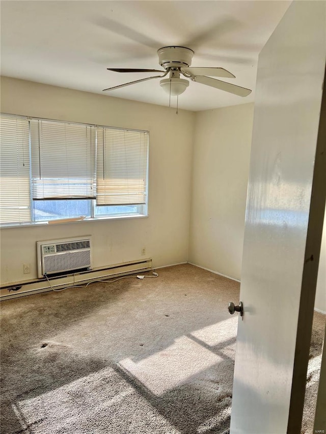 carpeted spare room featuring an AC wall unit and ceiling fan