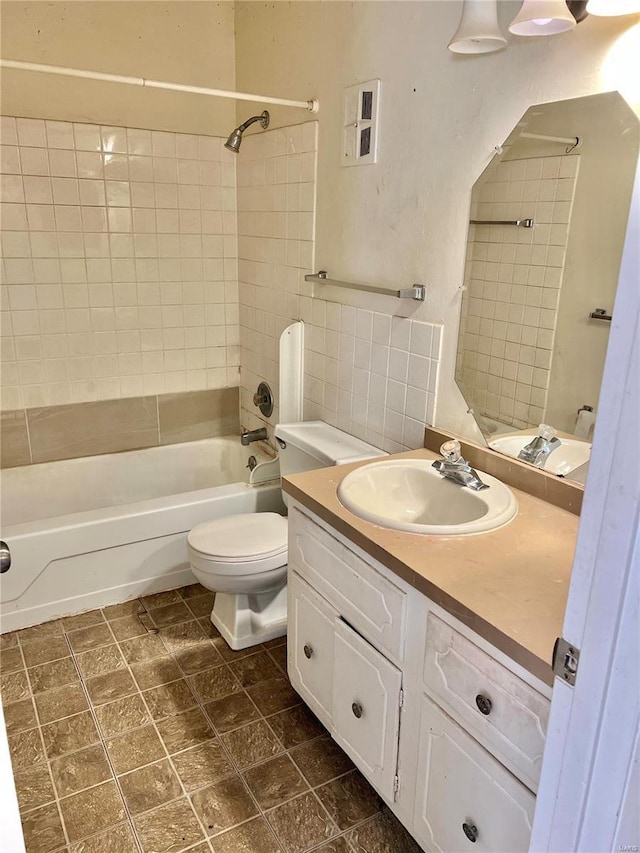 full bathroom featuring vanity, toilet, and tiled shower / bath