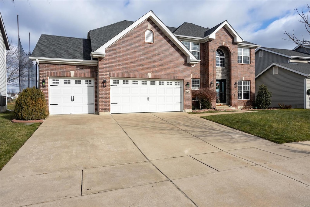 front of property with a front yard and central AC