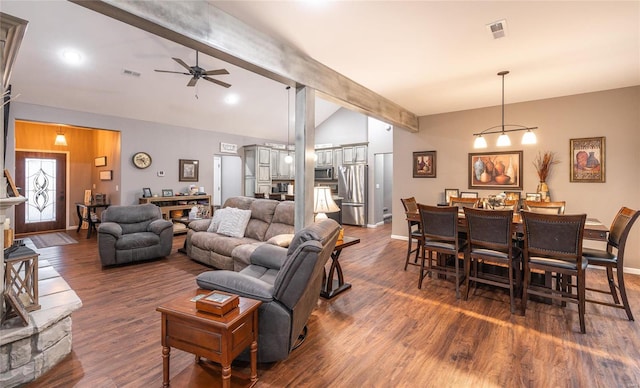 living room with vaulted ceiling with beams, ceiling fan, and dark wood-type flooring