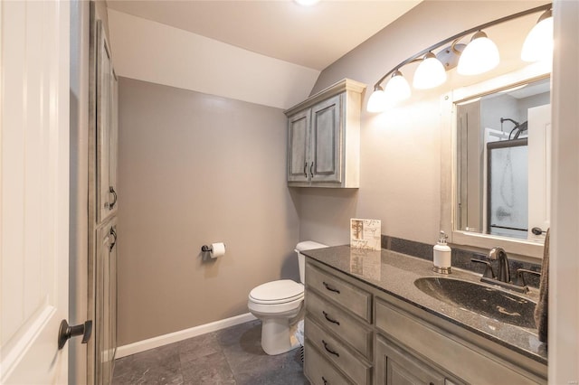 bathroom featuring tile patterned flooring, vanity, toilet, and vaulted ceiling