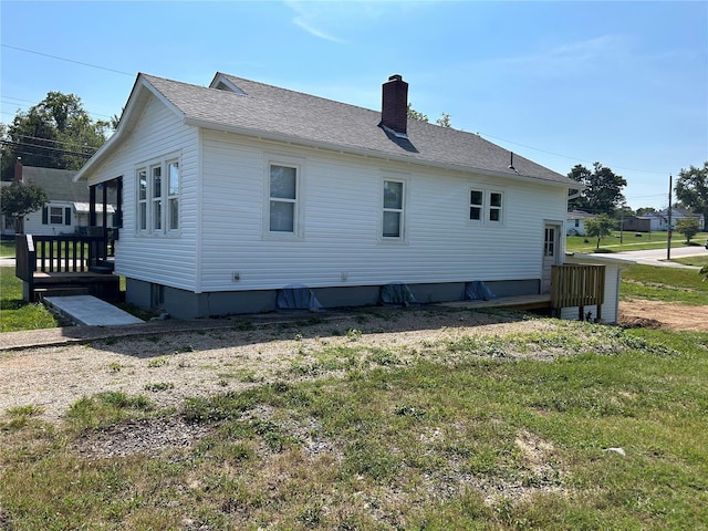 view of property exterior with a yard