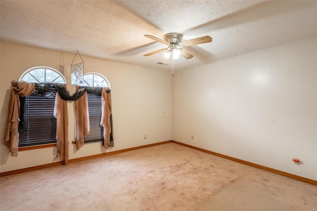 unfurnished room with carpet flooring, ceiling fan, and a textured ceiling