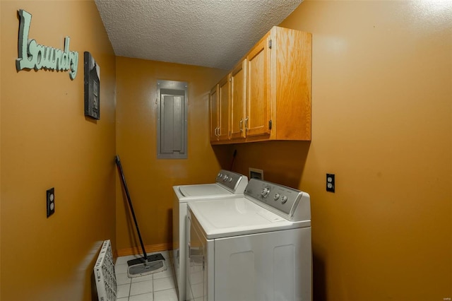 washroom with radiator, cabinets, electric panel, light tile patterned floors, and washer and dryer