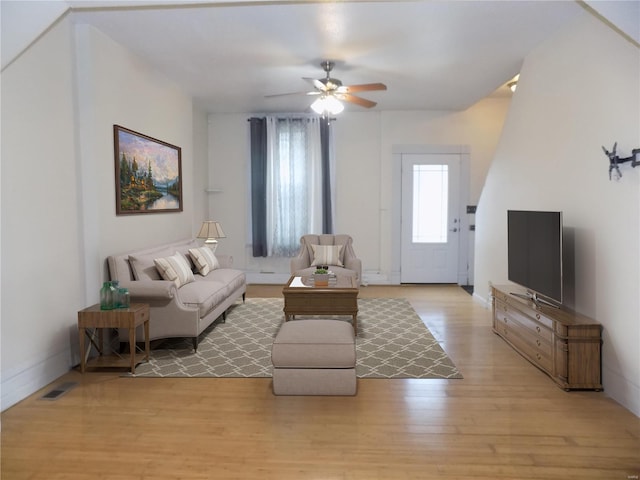 living room featuring light wood-type flooring and ceiling fan