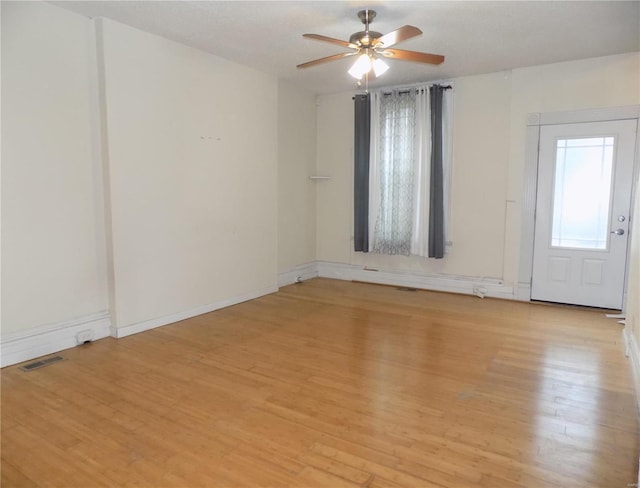 spare room featuring light hardwood / wood-style floors and ceiling fan