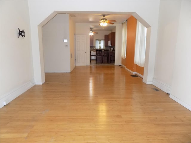 empty room featuring light wood-type flooring and ceiling fan