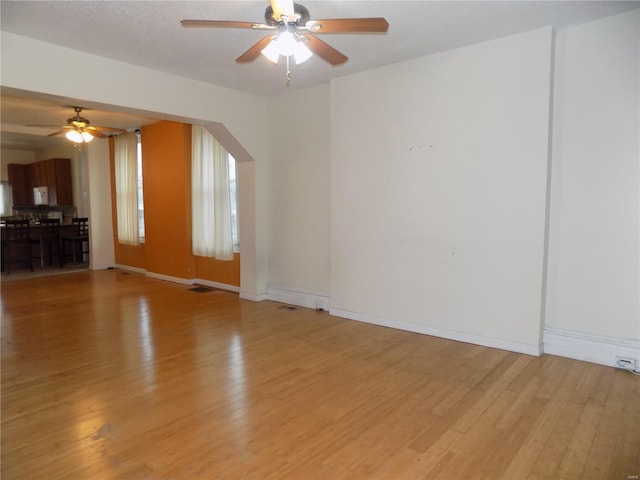 empty room featuring ceiling fan and light wood-type flooring