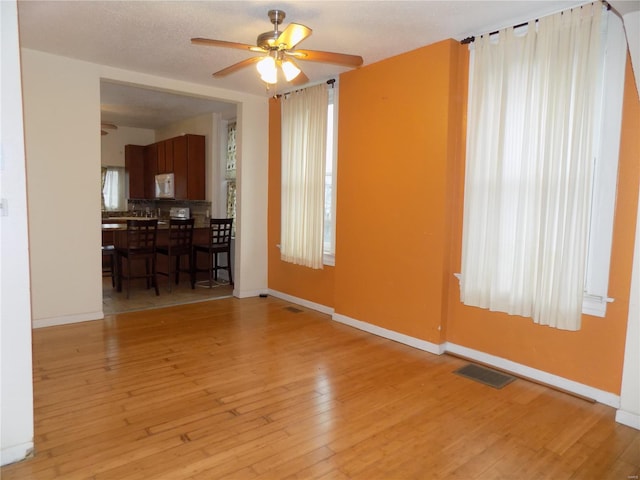 spare room featuring light hardwood / wood-style flooring and ceiling fan