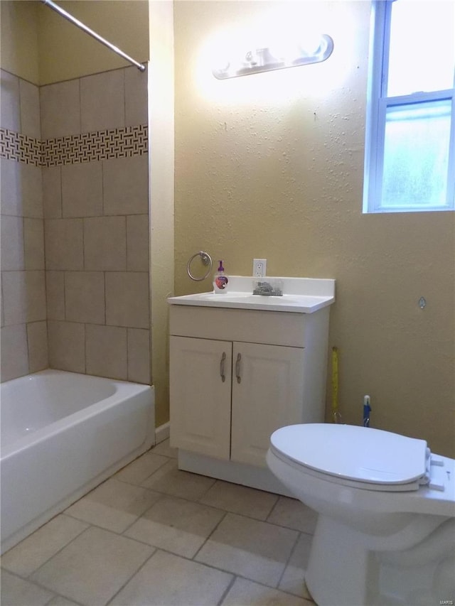 full bathroom featuring tile patterned flooring, vanity, toilet, and tiled shower / bath