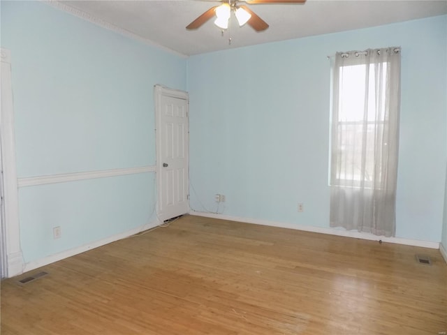 empty room featuring ceiling fan and light hardwood / wood-style flooring