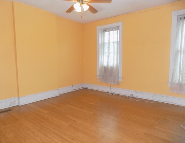 spare room featuring hardwood / wood-style flooring and ceiling fan