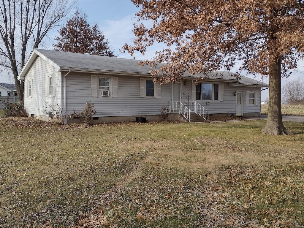 rear view of house with a yard