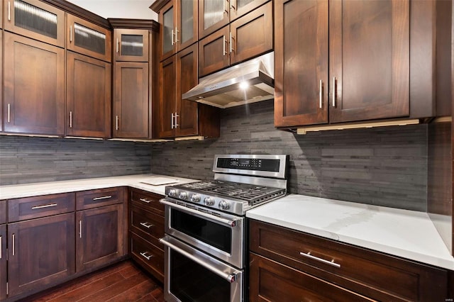 kitchen featuring backsplash, dark hardwood / wood-style floors, and range with two ovens