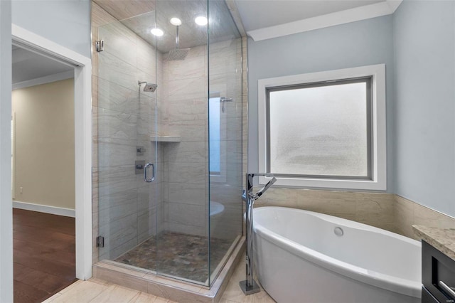 bathroom with plus walk in shower, vanity, tile patterned floors, and ornamental molding