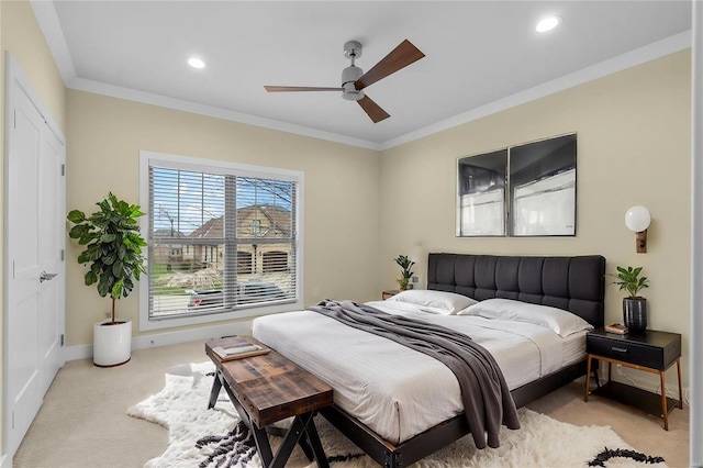 bedroom with ceiling fan, light colored carpet, and ornamental molding