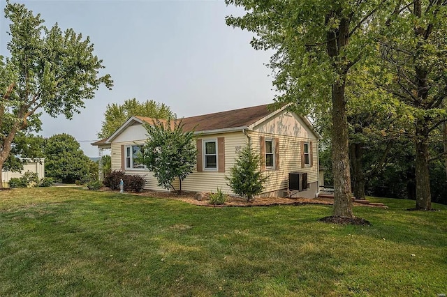 view of home's exterior featuring a yard and central AC unit