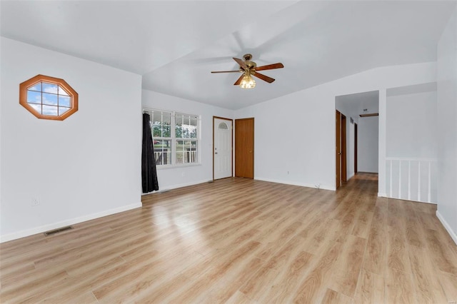 spare room featuring ceiling fan, light hardwood / wood-style floors, and vaulted ceiling