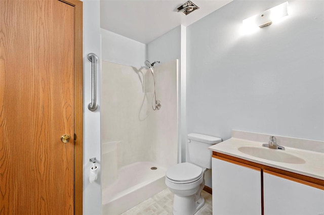 bathroom with vanity, toilet, and walk in shower