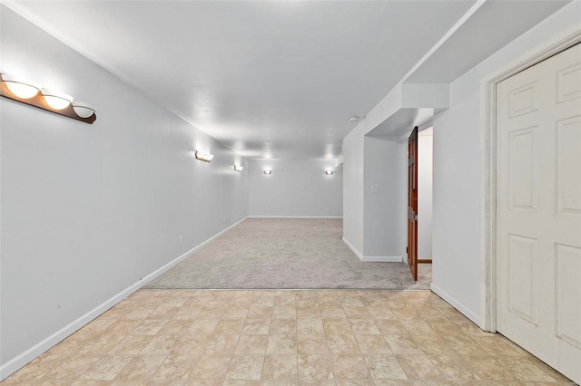 basement featuring light carpet