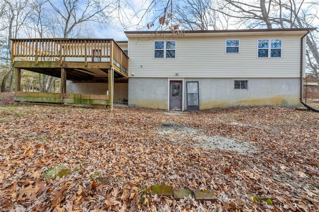 back of house featuring a wooden deck