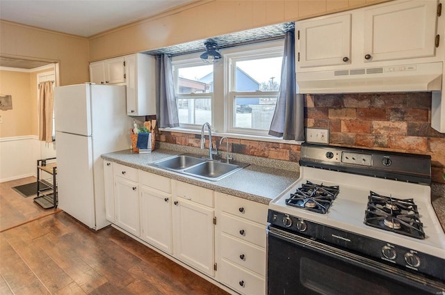 kitchen with white appliances, crown molding, dark wood-type flooring, sink, and white cabinetry