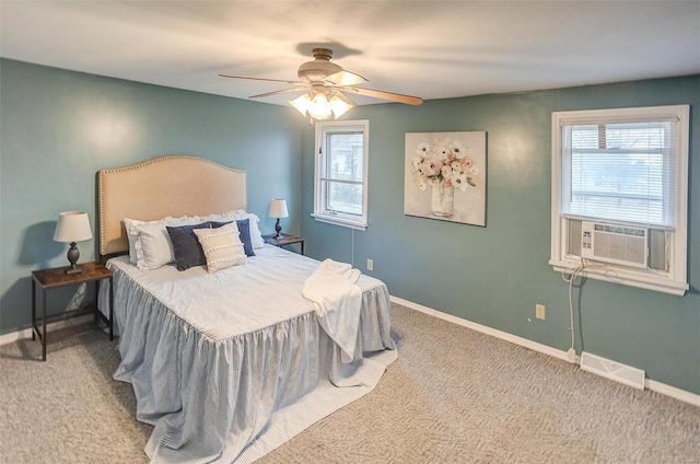 bedroom with light colored carpet, ceiling fan, and cooling unit